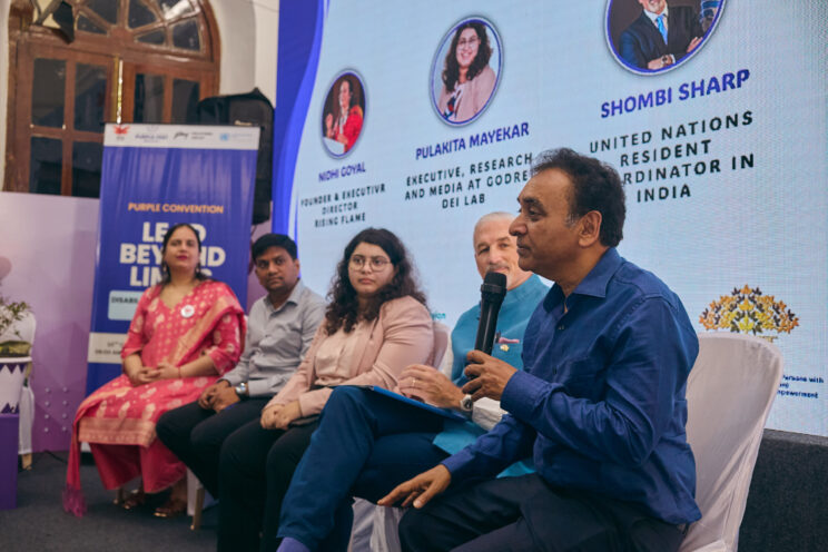 Close up of Shri Rajesh Aggarwal speaking with the other speakers to his right.