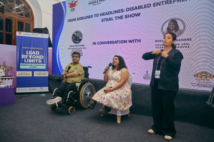 Nipun and Surashree during the session, with the ISL interpreter on the right. Surashree is speaking.