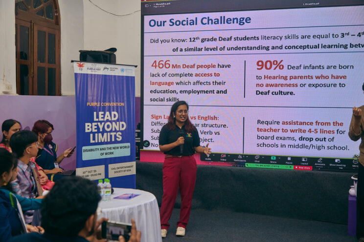 Shraddha pitching in front of the screen with her presentation on it.