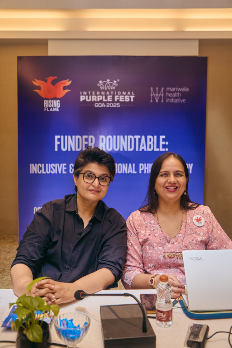 Raj Mariwala and Nidhi Ashok Goyal seated at a table in front of the banner for Funder Roundtable.