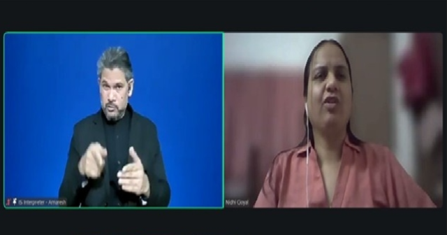 Screenshot of a Zoom meeting. Spotlighted are 2 windows. On the left is ISL Interpreter Amaresh and on the right is Nidhi Goyal, who is speaking. She is wearing a pink collared shirt.