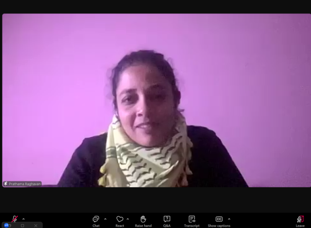 Dr. Prathama Raghavan is pinned on the screen. She is sitting in front of a purple/pink wall. She is wearing a black long-sleeve top and has a keffiyeh wrapped around her neck. Her hair is tied back.