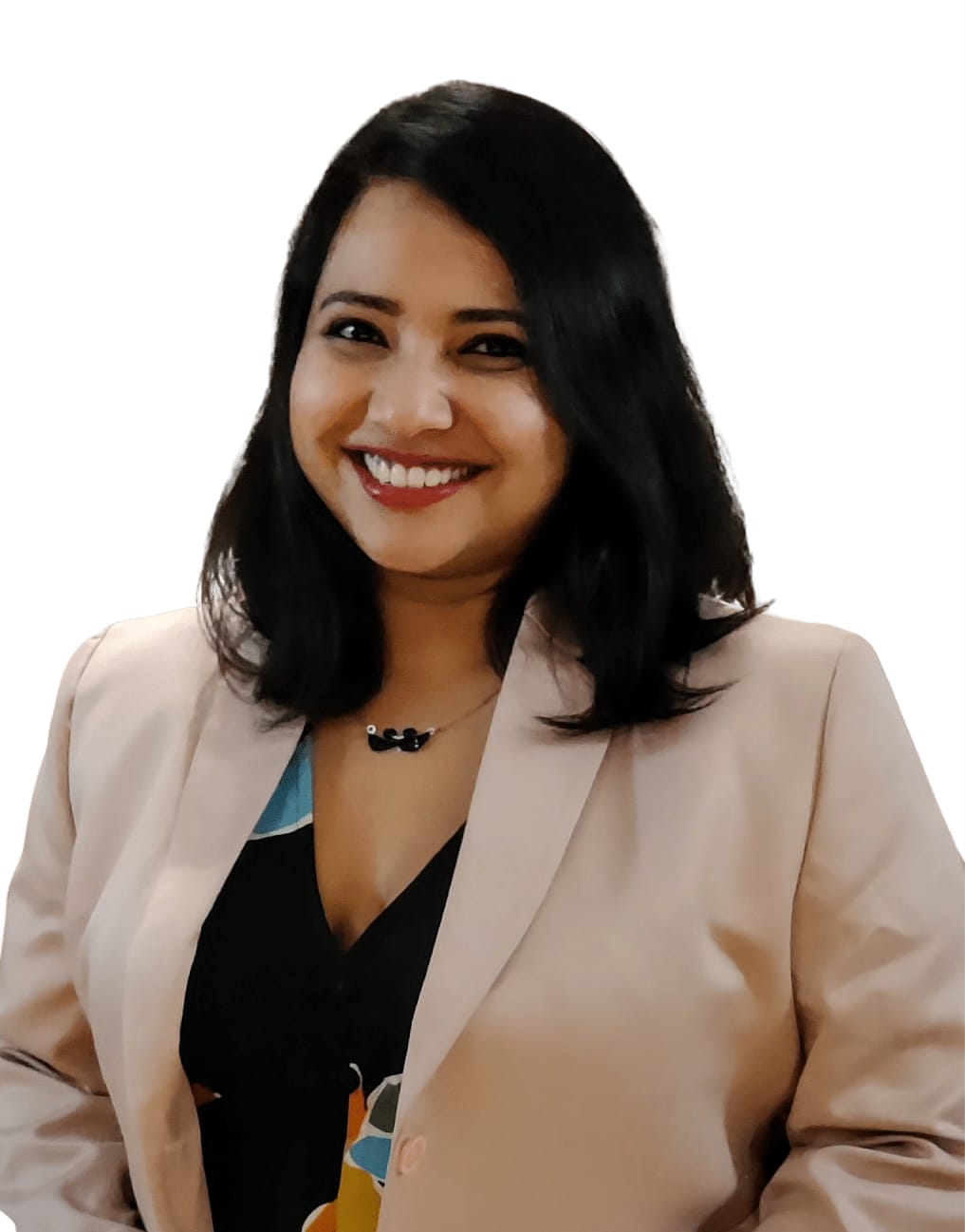 Surashree Rahane is an Indian woman with shoulder-length hair. She is wearing a light pink blazer over a black top, in a studio with a white background.